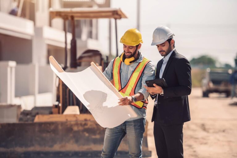 Civil engineer and construction worker manager holding digital tablet and blueprints talking and planing about construction site Cooperation teamwork concept