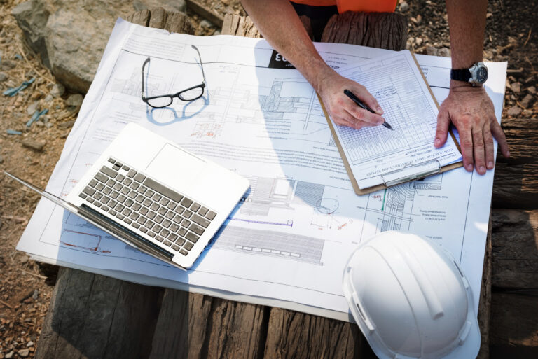 Site engineer on a construction site checking codes and regulations