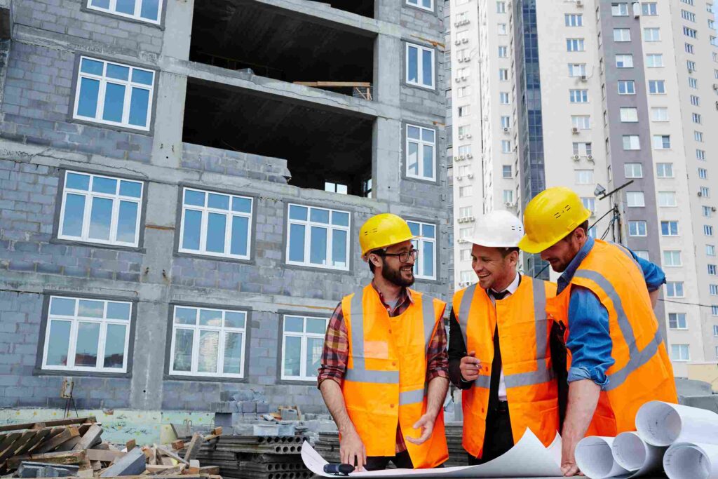 Engineers Working with blueprint of residential construction